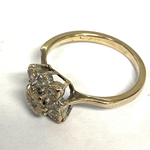 55 - An unmarked (rubbed) yellow and white metal diamond set flower ring, size L