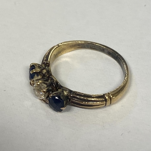 58 - A sapphire and diamond ring in unmarked yellow metal central old diamond, with round cut sapphire ac... 