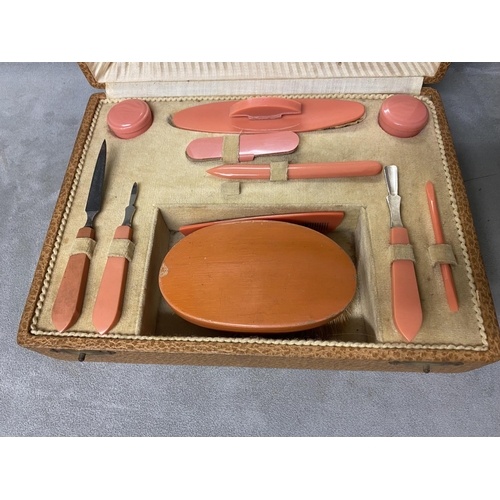 259 - A Mid C20th manicure set, in faux leather box, complete with mirror