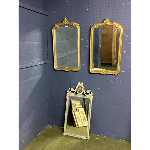 351 - Pair of gilt framed wall mirrors with scrolling borders and finial. Pair including frame 43cm W x 78... 