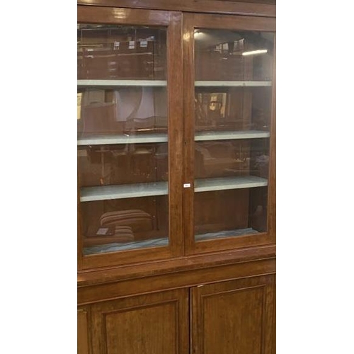 625 - A two-section mahogany bookcase, the upper section with two glazed panelled doors,  and a pair of cu... 