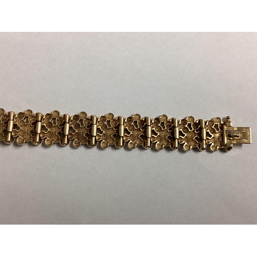 1 - A 9ct gold bracelet of pierced circular textured design. 18cm. 29g.