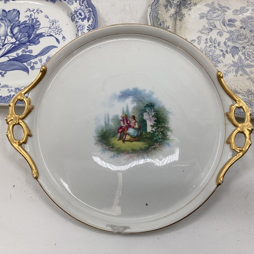 108 - Four blue and white serving dishes together with a porcelain circular tray with gilt handles, larges... 