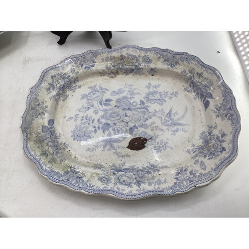 108 - Four blue and white serving dishes together with a porcelain circular tray with gilt handles, larges... 