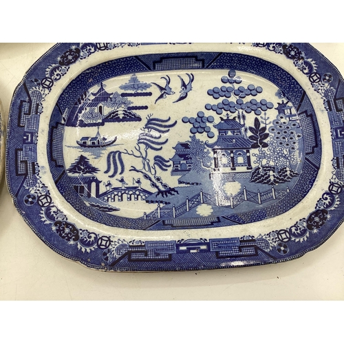 110 - Four ceramic Willow Pattern serving dishes, largest 43cm x 35cm (some wear etc, see images)