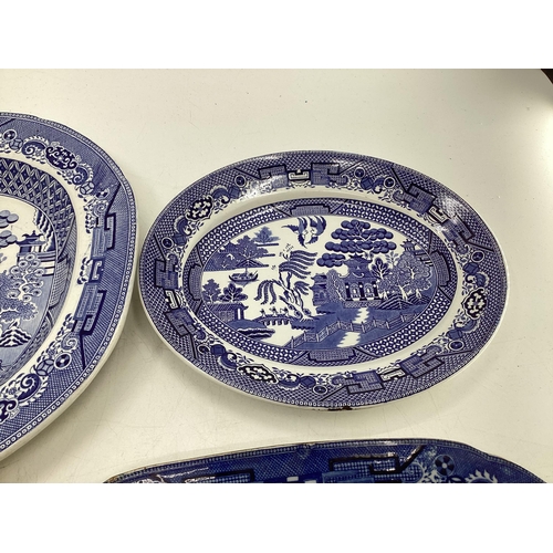 110 - Four ceramic Willow Pattern serving dishes, largest 43cm x 35cm (some wear etc, see images)