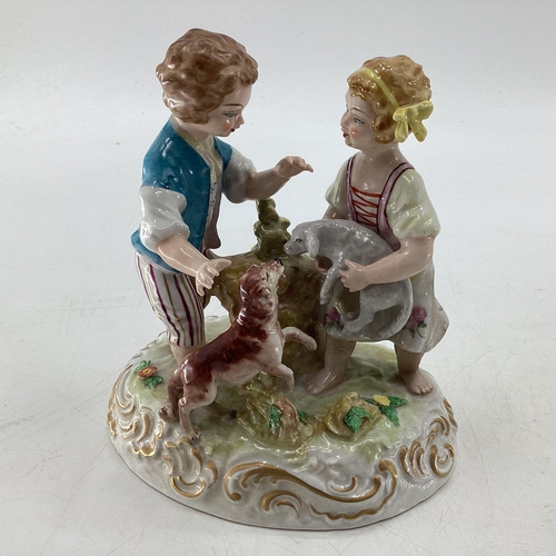 114 - Two Meissen style figural groups, blue crossed sword mark to base.  Largest is 19cm H (some wear and... 