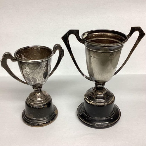 13 - Two Sterling silver and one white metal miniature trophies on turned wooden bases