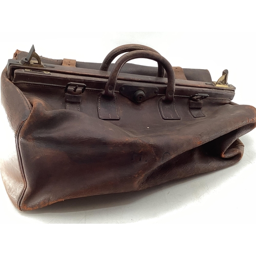 131 - Waxed Barbour cartridge bag, together with a late C19th/early C20th century leather Gladstone style ... 