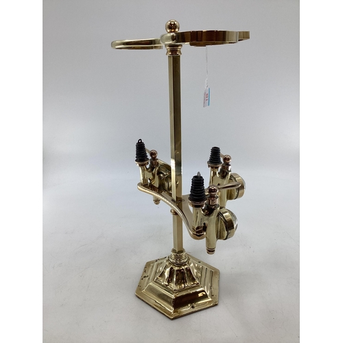 148 - An Edwardian brass free standing three bottle spirit dispenser by Gaskell and chambers, optic pearl ... 