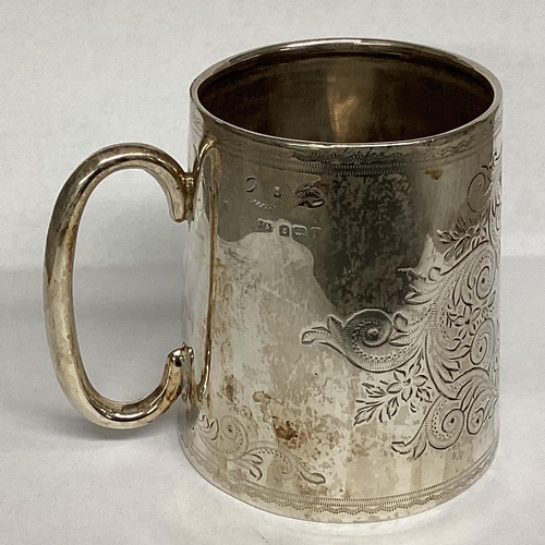 15 - A Sterling silver mug with chased scrolling decoration, loop handle, Birmingham 1910 7.5cmH, 96g