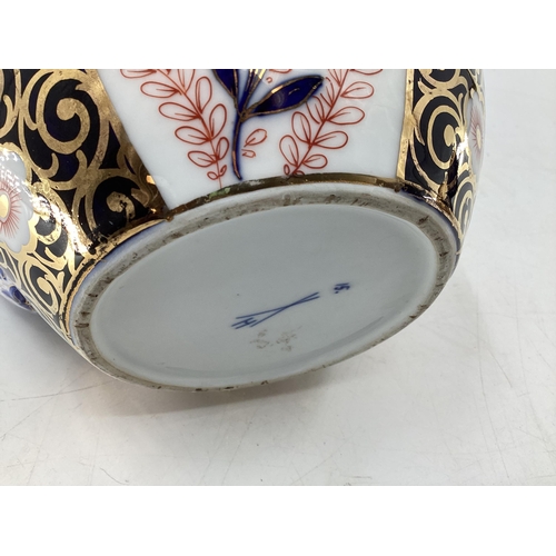 152 - A Royal Crown Derby Style Imari pattern tea pot, with silver plated loop handle, cross sword mark to... 