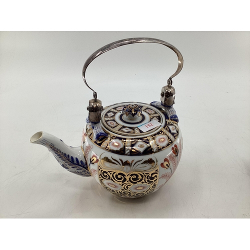 152 - A Royal Crown Derby Style Imari pattern tea pot, with silver plated loop handle, cross sword mark to... 