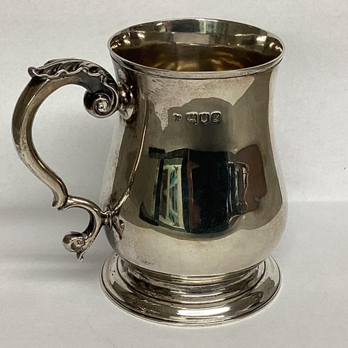 17 - A Sterling silver mug, circular stepped foot and scrolling handle 10cm(h), by Holland Aldwinkle and ... 