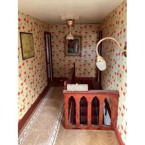 173 - A large well fitted dolls house with numerous accessories and a large quantity of furniture, rugs et... 