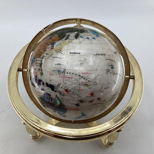 175 - A table top gem set globe in gilt metal mount with compass to base, 27cmH