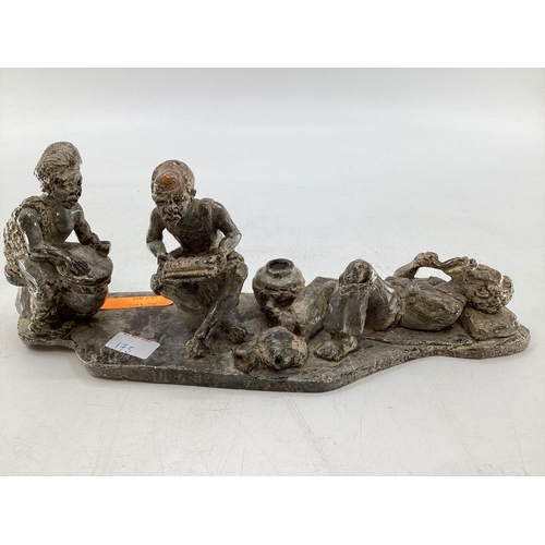 183 - An African hardstone figural group, indistinctly signed and dated to base, 39 x 14 x 11cm