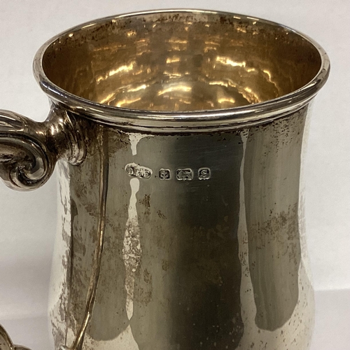 2 - A Sterling silver mug, scroll handle on circular foot by Deakin and Francis, Birmingham, 1942.  378g