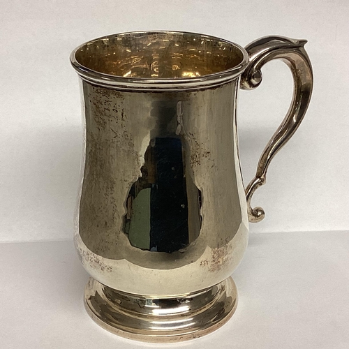 2 - A Sterling silver mug, scroll handle on circular foot by Deakin and Francis, Birmingham, 1942.  378g