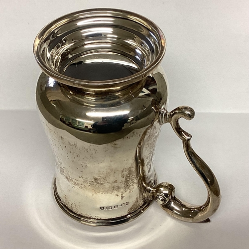 2 - A Sterling silver mug, scroll handle on circular foot by Deakin and Francis, Birmingham, 1942.  378g