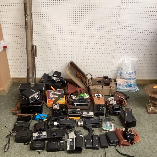 269 - A large collection of C20th cameras, cine and a projector and screen. Quantity.