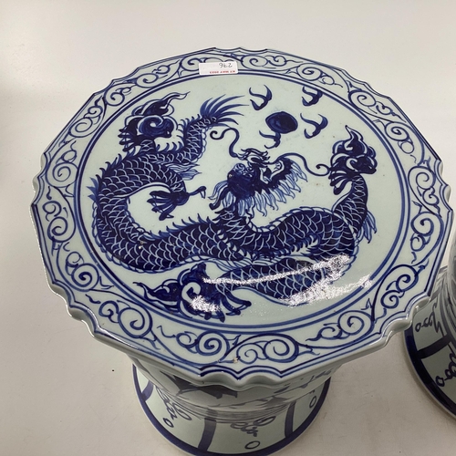 276 - A pair of Oriental style ceramic blue and white garden or conservatory seats with Dragon decoration ... 