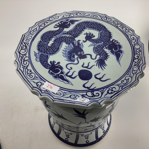 276 - A pair of Oriental style ceramic blue and white garden or conservatory seats with Dragon decoration ... 