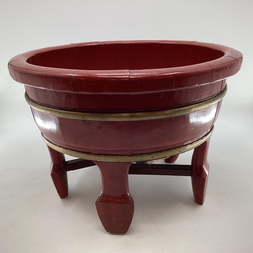 282 - A Chinese brass bound lacquer wash bowl of circular form, with wide flat bottom, raised on four feet... 