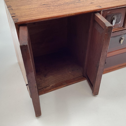 285 - An Early C20th Chinese table top cabinet, two cupboard doors with two long and two short drawers, 56... 