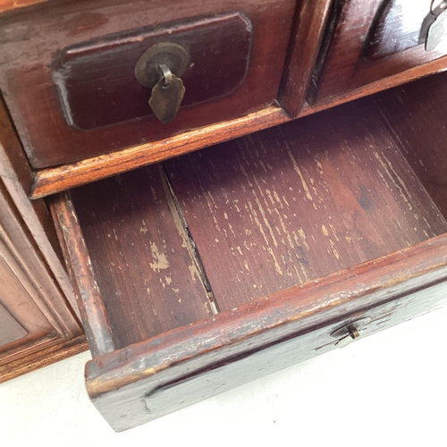 285 - An Early C20th Chinese table top cabinet, two cupboard doors with two long and two short drawers, 56... 