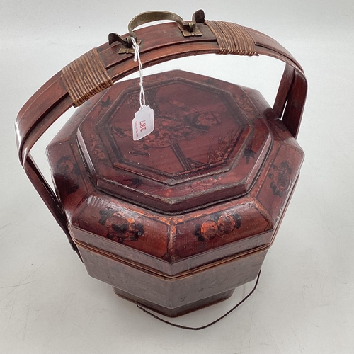 287 - A C19th style Chinese lacquer rice box, of octagonal form with curved handle