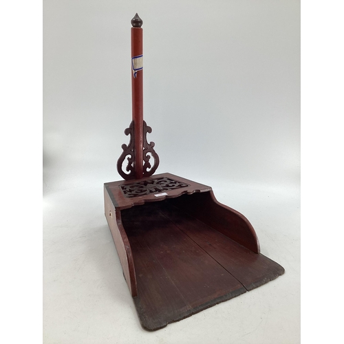 299 - A large stylised Chinese lacquered dust pan with pierced design, 69 x 49 x 39cm