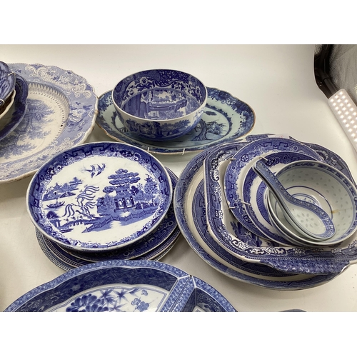 321 - Large collection of blue and white ceramics to include Willow pattern meat plates, bowls etc