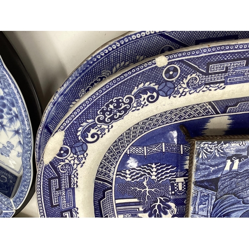 321 - Large collection of blue and white ceramics to include Willow pattern meat plates, bowls etc