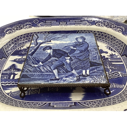 321 - Large collection of blue and white ceramics to include Willow pattern meat plates, bowls etc