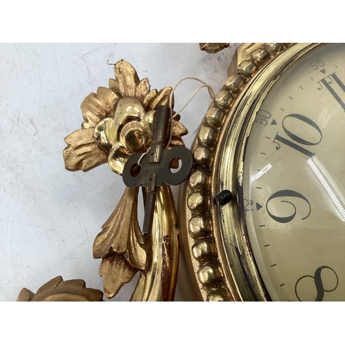 329 - French giltwood cartel wall clock with domed glass white metal face with Arabic markers decorated wi... 