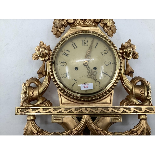 329 - French giltwood cartel wall clock with domed glass white metal face with Arabic markers decorated wi... 