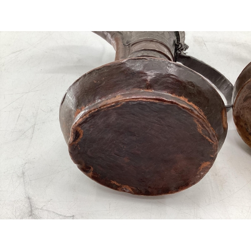 332 - Two middle eastern copper coffee pots with traditional chased design, largest 34cm