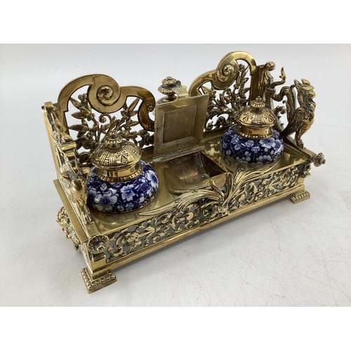 333 - Brass desk tidy/inkwell with two ceramic inkwells and lidded recess for stamps, together with brass ... 