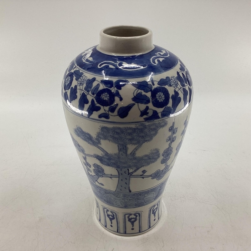 339 - Oriental style blue and white vase of waisted form with square blue character mark to base 33 cm H