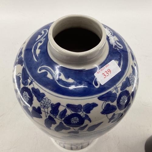 339 - Oriental style blue and white vase of waisted form with square blue character mark to base 33 cm H