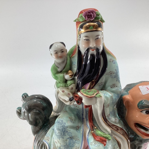 343 - Three polychrome painted oriental deities Fu Lu and Shou, all seated on various mythical beasts, all... 