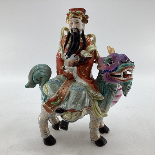 343 - Three polychrome painted oriental deities Fu Lu and Shou, all seated on various mythical beasts, all... 