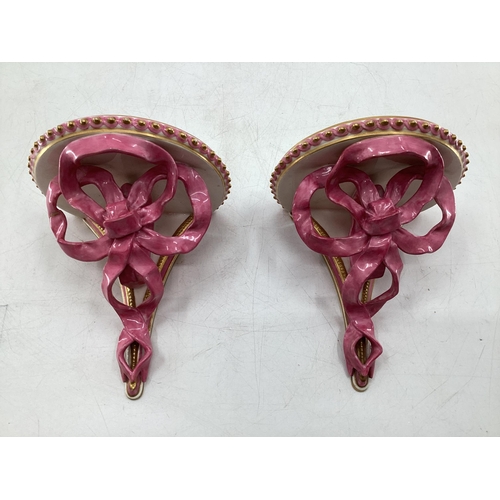 344 - Pair of Royal Worcester Style ceramic wall brackets with pink ribbon and gilt decoration 15cm x 10cm