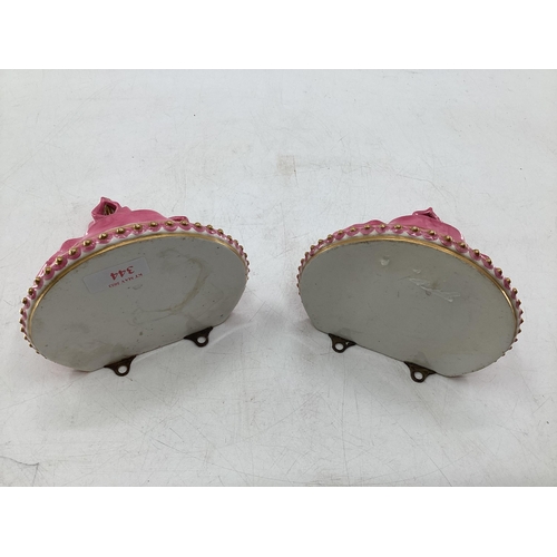 344 - Pair of Royal Worcester Style ceramic wall brackets with pink ribbon and gilt decoration 15cm x 10cm