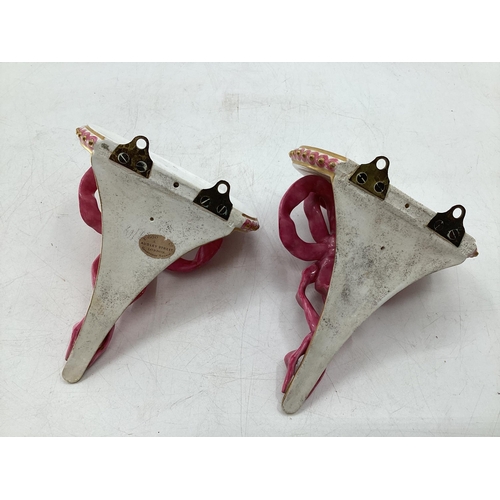 344 - Pair of Royal Worcester Style ceramic wall brackets with pink ribbon and gilt decoration 15cm x 10cm