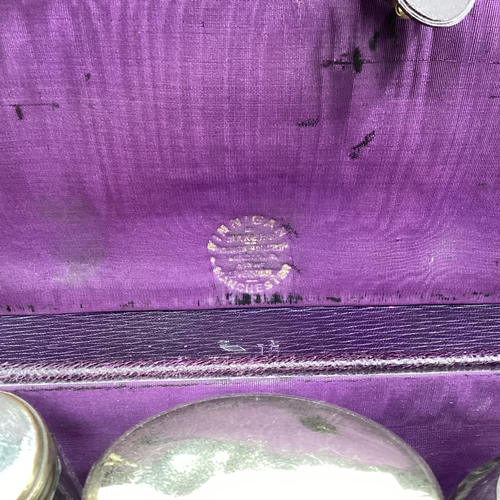 348 - Vintage purple leather travel vanity case with fitted interior containing numerous white metal toppe... 