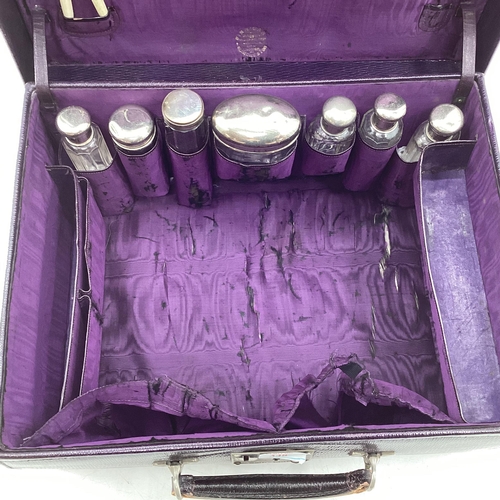 348 - Vintage purple leather travel vanity case with fitted interior containing numerous white metal toppe... 