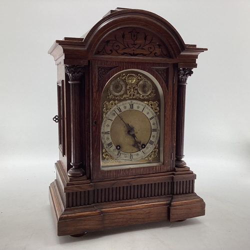 350 - C19th Oak cased mantle clock of large proportions, arched dial with silver chapter ring, gilt spandr... 