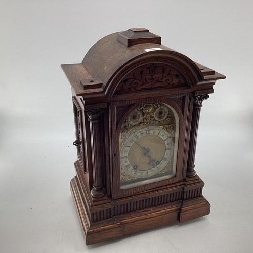 350 - C19th Oak cased mantle clock of large proportions, arched dial with silver chapter ring, gilt spandr... 